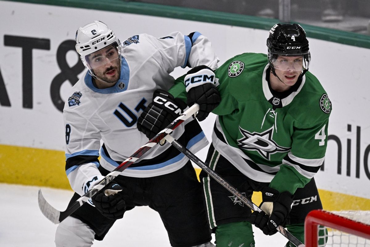 Jan 4, 2025; Dallas, Texas, USA; Utah Hockey Club center Nick Schmaltz (8) and Dallas Stars defenseman Miro Heiskanen (4) look for the puck in the Stars zone during the first period at the American Airlines Center. Mandatory Credit: Jerome Miron-Imagn Images