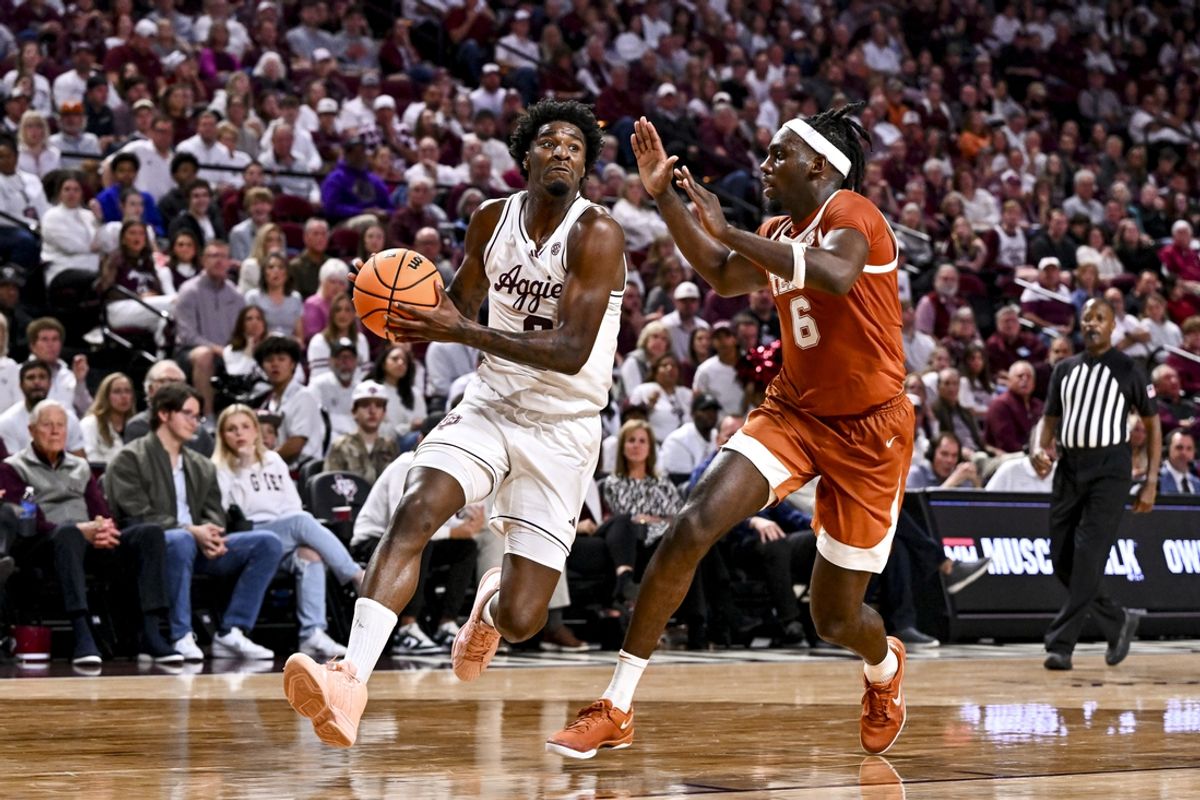 Jan 4, 2025; College Station, Texas, USA; Texas A&M Aggies forward Solomon Washington (9) drives to the basket as Texas Longhorns forward Arthur Kaluma (6) defends during the first half at Reed Arena. Mandatory Credit: Maria Lysaker-Imagn Images