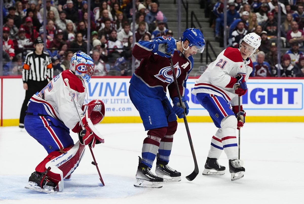 Jan 4, 2025; Denver, Colorado, USA; Colorado Avalanche right wing Mikko Rantanen (96) and Montreal Canadiens goaltender Jakub Dobes (75) and defenseman Kaiden Guhle (21) during the second period at Ball Arena. Mandatory Credit: Ron Chenoy-Imagn Images