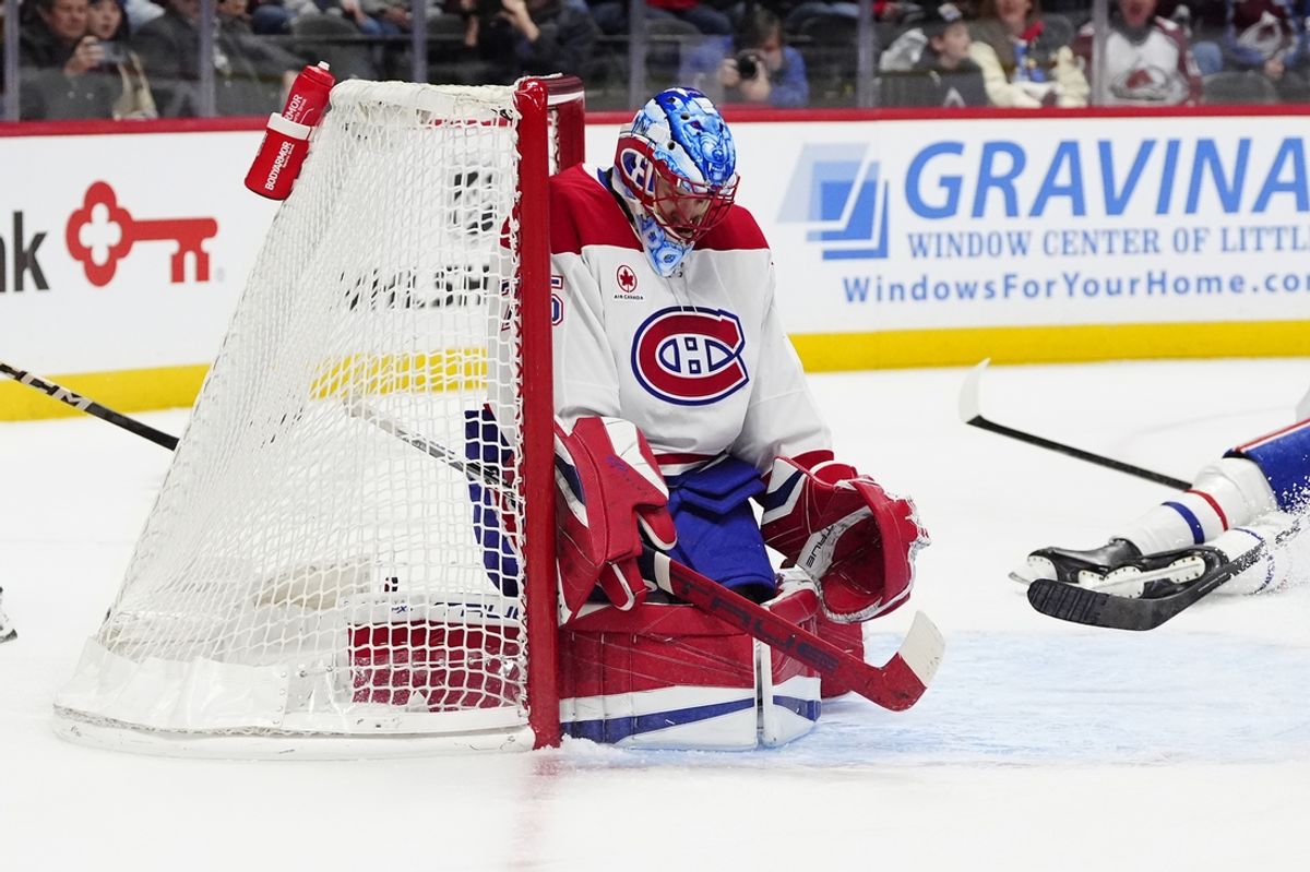 Jan 4, 2025; Denver, Colorado, USA; Montreal Canadiens goaltender Jakub Dobes (75) makes a save in the second period against the Colorado Avalanche at Ball Arena. Mandatory Credit: Ron Chenoy-Imagn Images