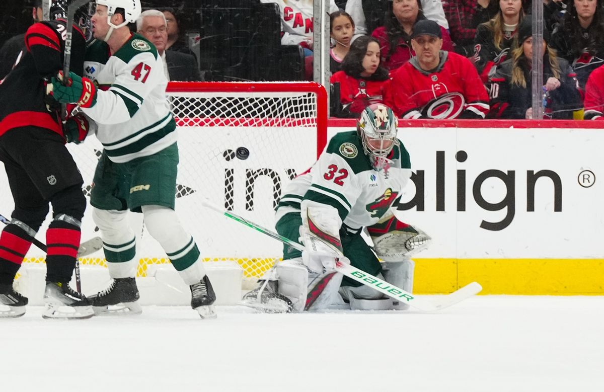 Jan 4, 2025; Raleigh, North Carolina, USA;  Minnesota Wild goaltender Filip Gustavsson (32) watches the shot against the Carolina Hurricanes during the second period at Lenovo Center. Mandatory Credit: James Guillory-Imagn Images