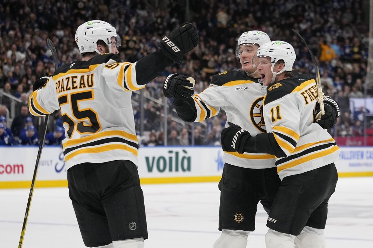 Jan 4, 2025; Toronto, Ontario, CAN; Boston Bruins forward Justin Brazeau (55) and defenceman Nikita Zadorov (91) congratulate forward Trent Frederic (11) on his goal against the Toronto Maple Leafs during the second period at Scotiabank Arena. Mandatory Credit: John E. Sokolowski-Imagn Images