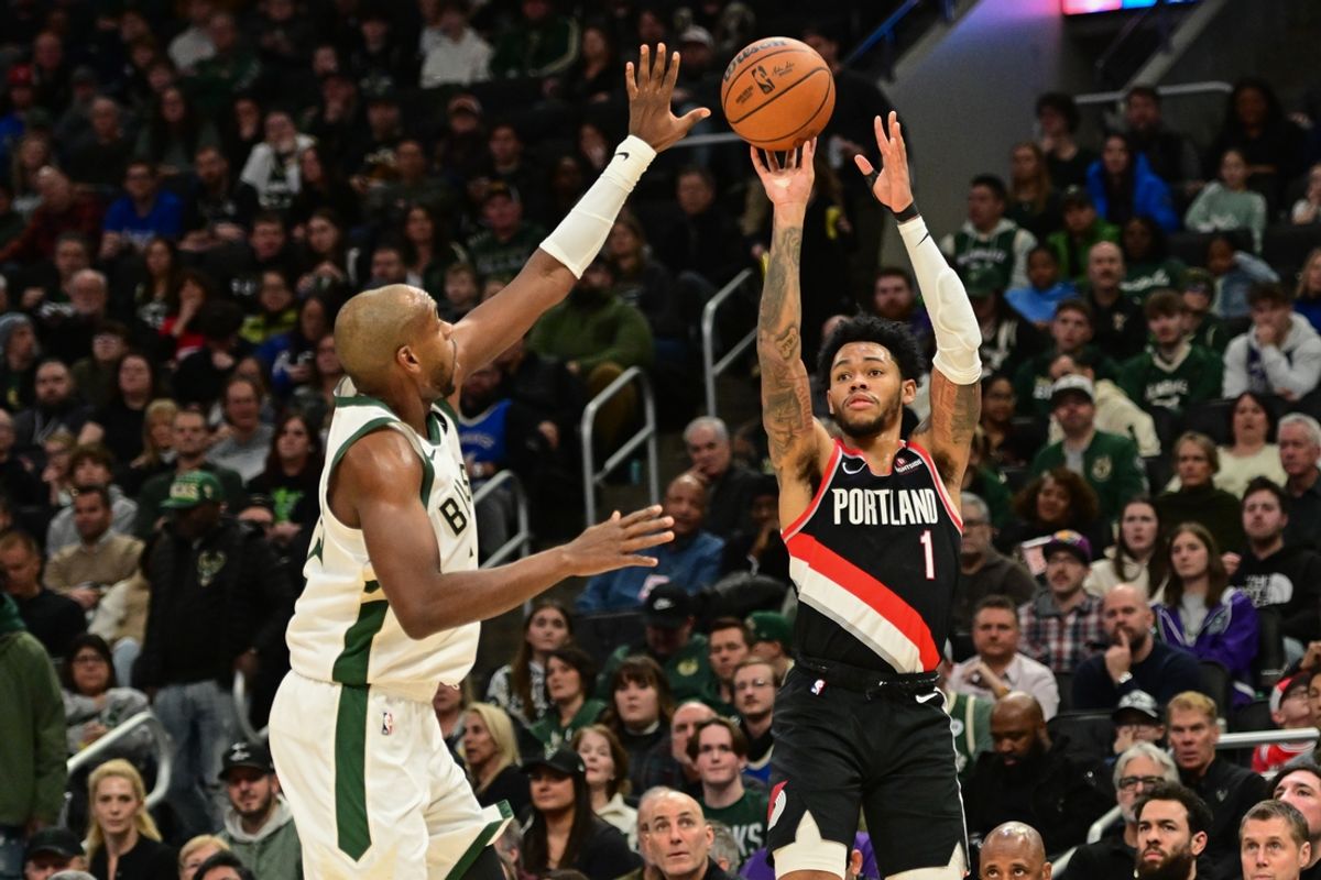 Jan 4, 2025; Milwaukee, Wisconsin, USA;  Portland Trail Blazers guard Anfernee Simons (1) takes a shot against Milwaukee Bucks forward Khris Middleton (22) in he second quarter at Fiserv Forum. Mandatory Credit: Benny Sieu-Imagn Images