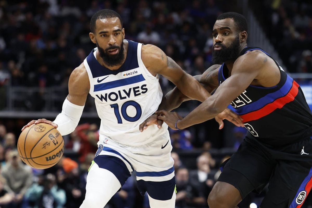 Jan 4, 2025; Detroit, Michigan, USA;  Minnesota Timberwolves guard Mike Conley (10) dribbles defended by Detroit Pistons forward Tim Hardaway Jr. (8) in the second half at Little Caesars Arena. Mandatory Credit: Rick Osentoski-Imagn Images