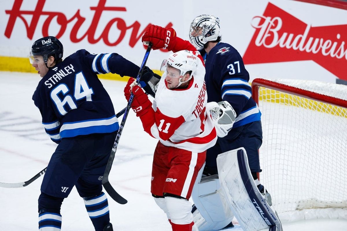 Jan 4, 2025; Winnipeg, Manitoba, CAN;  Detroit Red Wings forward Vladimir Tarasenko (11) jostles for position with Winnipeg Jets defenseman Logan Stanley (64) during the third period at Canada Life Centre. Mandatory Credit: Terrence Lee-Imagn Images
