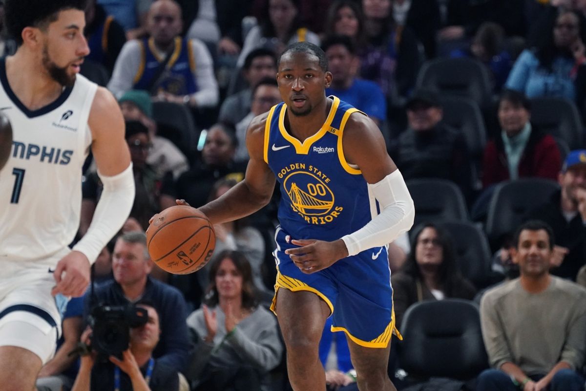 Jan 4, 2025; San Francisco, California, USA;  Golden State Warriors forward Jonathan Kuminga (00) dribbles up court in front of Memphis Grizzlies guard Scotty Pippen Jr. (1) in the second quarter at Chase Center. Mandatory Credit: David Gonzales-Imagn Images