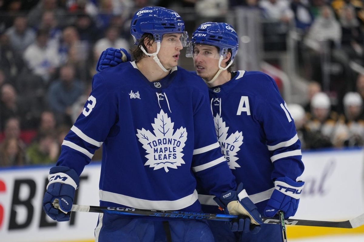 Jan 4, 2025; Toronto, Ontario, CAN; Toronto Maple Leafs forward Mitch Marner (16) talks to forward Matthew Knies (23) during a break in the action against the Boston Bruins during the third period at Scotiabank Arena. Mandatory Credit: John E. Sokolowski-Imagn Images