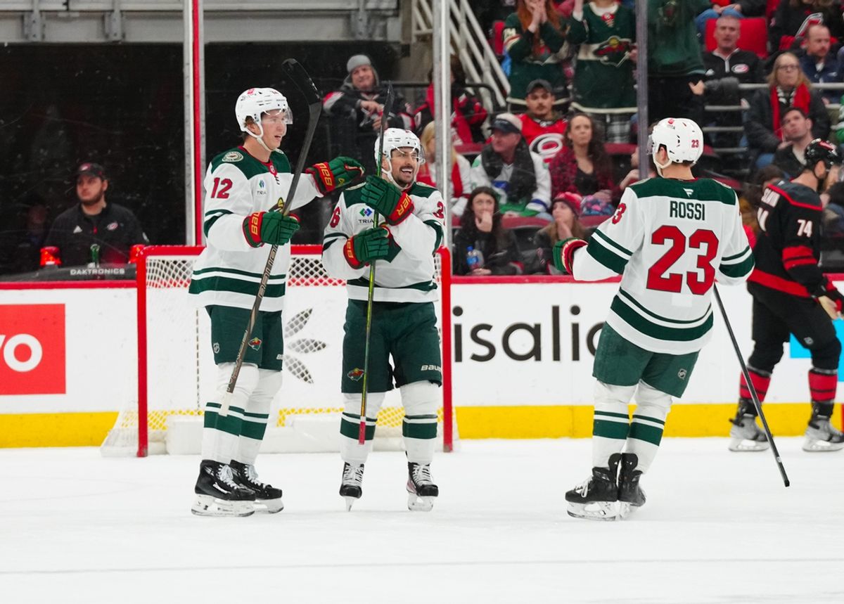 Jan 4, 2025; Raleigh, North Carolina, USA;  Minnesota Wild right wing Mats Zuccarello (36) celebrates his empty net goal with left wing Matt Boldy (12) and center Marco Rossi (23) against the Carolina Hurricanes during the third period at Lenovo Center. Mandatory Credit: James Guillory-Imagn Images