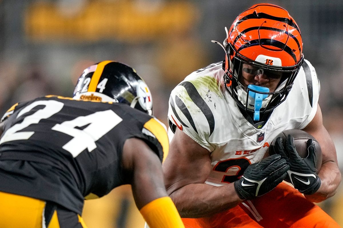 Cincinnati Bengals running back Khalil Herbert (34) is met by Pittsburgh Steelers cornerback Joey Porter Jr. (24) on a carry in the second quarter of the NFL Week 18 game between the Pittsburgh Steelers and the Cincinnati Bengals at Acrisure Stadium in Pittsburgh on Saturday, Jan. 4, 2025.