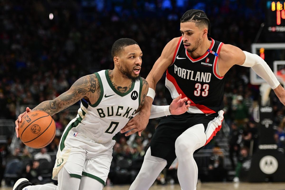 Jan 4, 2025; Milwaukee, Wisconsin, USA;  Milwaukee Bucks guard Damian Lillard (0) drives for the basket against Portland Trail Blazers forward Toumani Camara (33) in the third quarter at Fiserv Forum. Mandatory Credit: Benny Sieu-Imagn Images