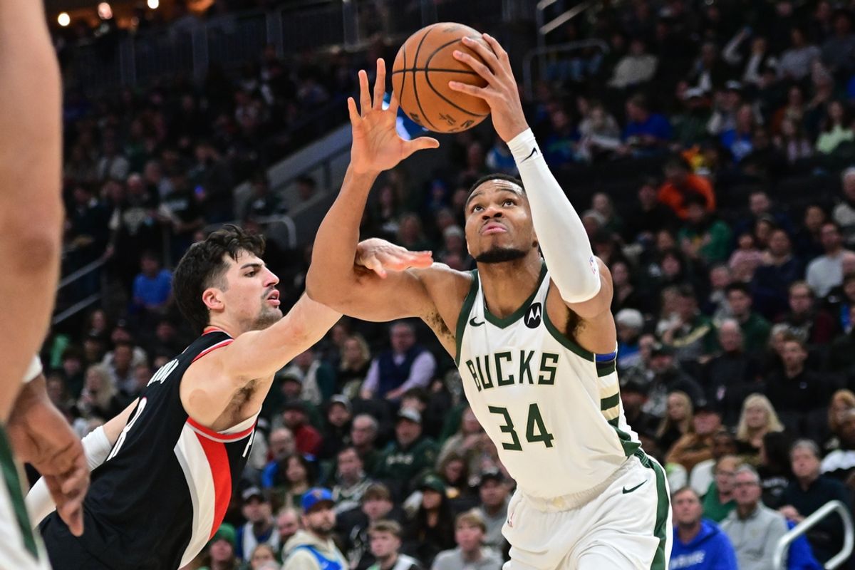 Jan 4, 2025; Milwaukee, Wisconsin, USA;  Milwaukee Bucks forward Giannis Antetokounmpo (34) takes a shot against Portland Trail Blazers forward Deni Avdija (8) in the third quarter at Fiserv Forum. Mandatory Credit: Benny Sieu-Imagn Images