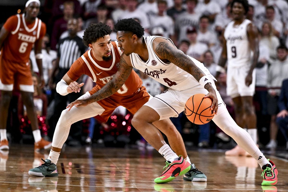 Jan 4, 2025; College Station, Texas, USA; Texas A&M Aggies guard Wade Taylor IV (4) controls the ball as Texas Longhorns guard Jordan Pope (0) defends during the second half at Reed Arena. The Aggies defeated the Longhorns 80-60. Mandatory Credit: Maria Lysaker-Imagn Images