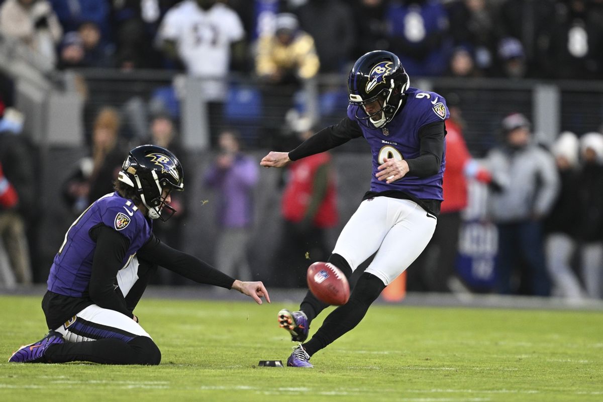 Jan 4, 2025; Baltimore, Maryland, USA;  Baltimore Ravens place kicker Justin Tucker (9) kicks off as  punter Jordan Stout (11) holds during the first quarter against the Cleveland Browns at M&T Bank Stadium. Mandatory Credit: Tommy Gilligan-Imagn Images