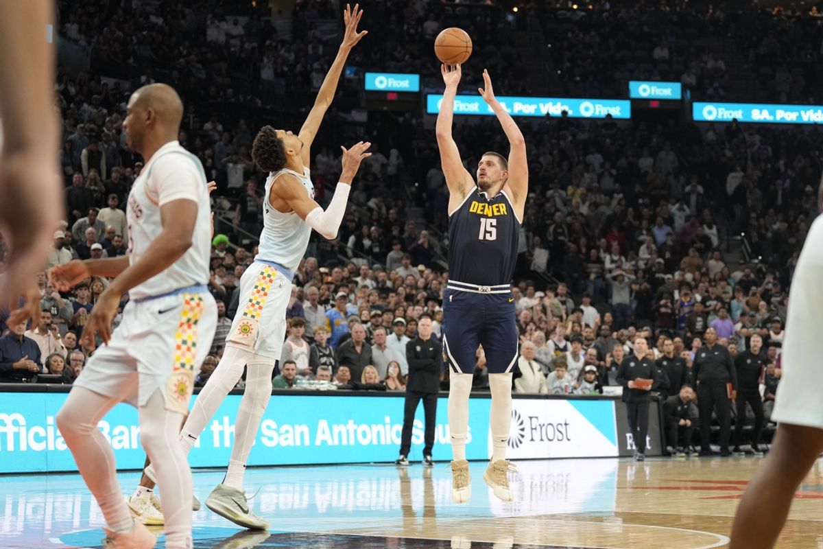 Jan 4, 2025; San Antonio, Texas, USA;  Denver Nuggets center Nikola Jokic (15) shoots the ball over San Antonio Spurs center Victor Wembanyama (1) during the second half at Frost Bank Center. Mandatory Credit: Scott Wachter-Imagn Images