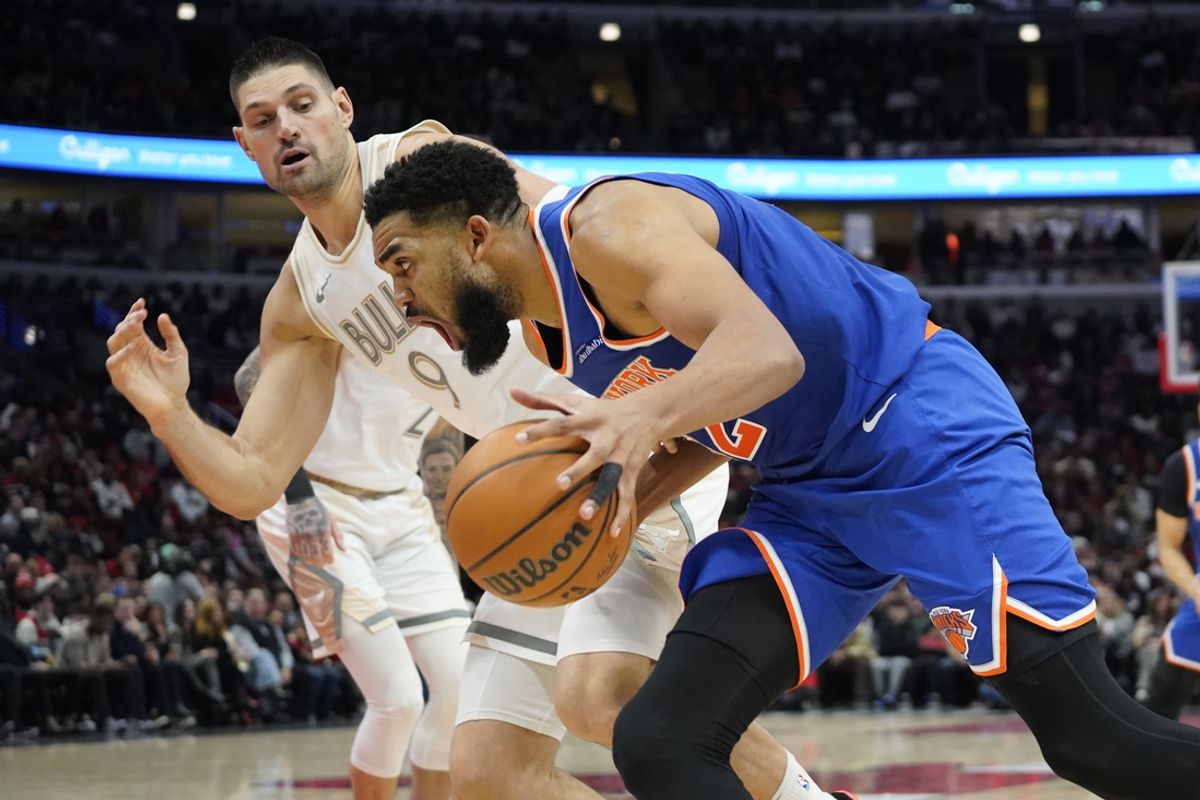 Jan 4, 2025; Chicago, Illinois, USA; New York Knicks center Karl-Anthony Towns (32) dribbles the ball against Chicago Bulls center Nikola Vucevic (9) during the second half at United Center. Mandatory Credit: David Banks-Imagn Images