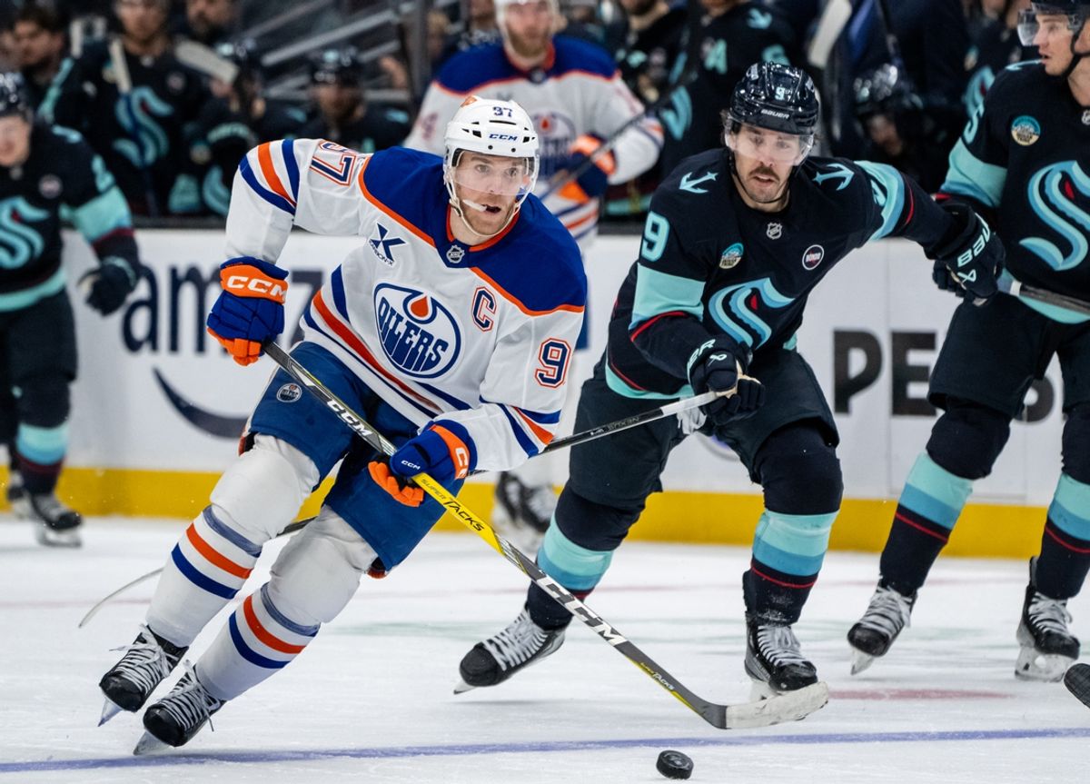 Jan 4, 2025; Seattle, Washington, USA;  Edmonton Oilers forward Connor McDavid (97) skates against Seattle Kraken forward Chandler Stephenson (9) during the second period at Climate Pledge Arena. Mandatory Credit: Stephen Brashear-Imagn Images