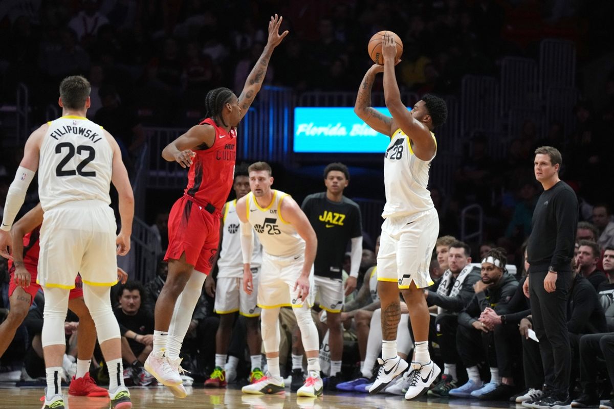 Jan 4, 2025; Miami, Florida, USA;  Utah Jazz forward Brice Sensabaugh (28) shoots over Miami Heat guard Josh Christopher (8) during the second half at Kaseya Center. Mandatory Credit: Jim Rassol-Imagn Images