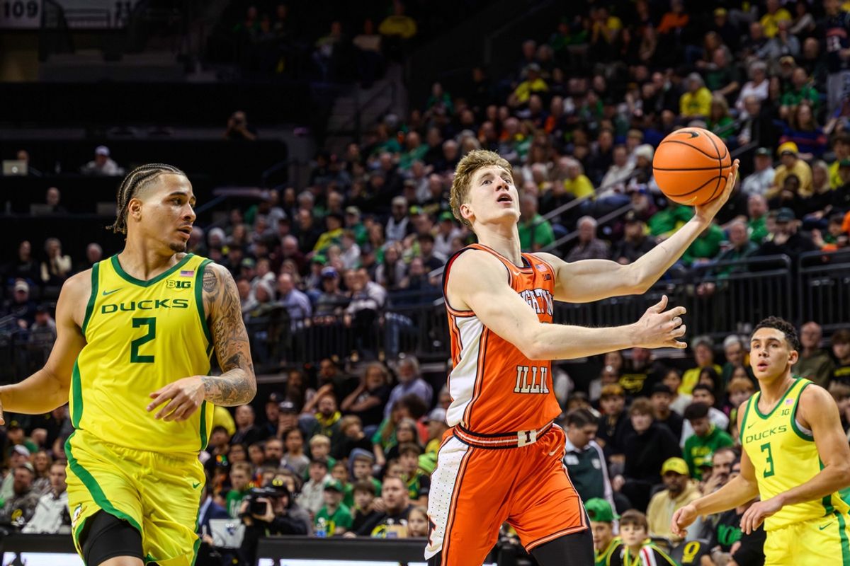Jan 2, 2025; Eugene, Oregon, USA; Illinois Fighting Illini guard Kasparas Jakucionis (32) drives for a layup past Oregon Ducks guard Jadrian Tracey (2) during the second half at Matthew Knight Arena. Mandatory Credit: Craig Strobeck-Imagn Images