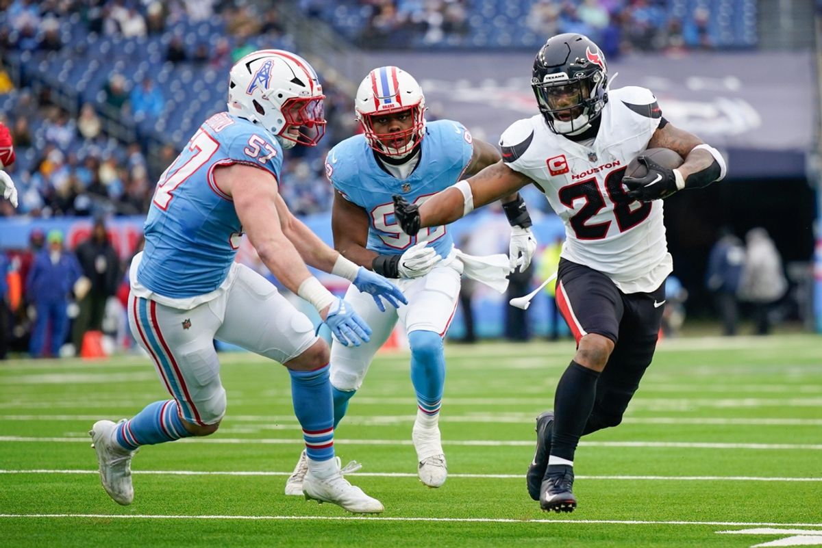 Houston Texans running back Joe Mixon (28) runs past Tennessee Titans linebacker Luke Gifford (57) during the first quarter at Nissan Stadium in Nashville, Tenn., Sunday, Jan. 5, 2025.