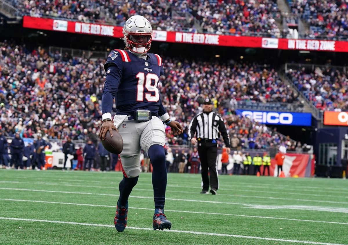 Jan 5, 2025; Foxborough, Massachusetts, USA; New England Patriots quarterback Joe Milton III (19) runs the ball for a touchdown against the Buffalo Bills in the first quarter at Gillette Stadium. Mandatory Credit: David Butler II-Imagn Images
