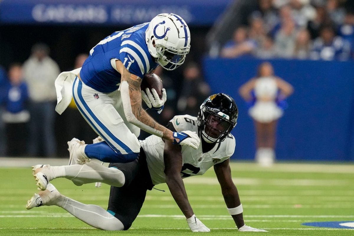 Indianapolis Colts wide receiver Michael Pittman Jr. (11) falls over Jacksonville Jaguars safety Darnell Savage (6) on Sunday, Jan. 5, 2025, during a game against the Jacksonville Jaguars at Lucas Oil Stadium in Indianapolis.