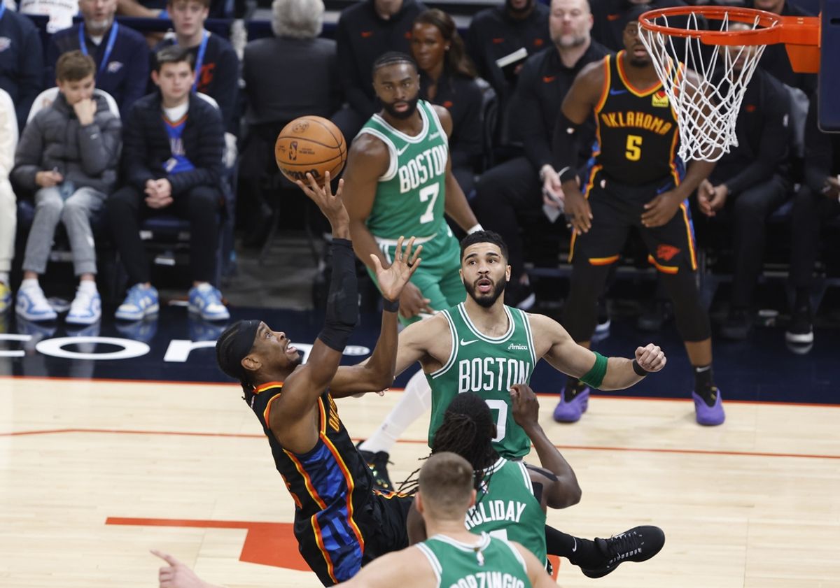 Jan 5, 2025; Oklahoma City, Oklahoma, USA; Oklahoma City Thunder guard Shai Gilgeous-Alexander (2) shoots the ball defended by Boston Celtics forward Jayson Tatum (0) during the first quarter at Paycom Center. Mandatory Credit: Alonzo Adams-Imagn Images