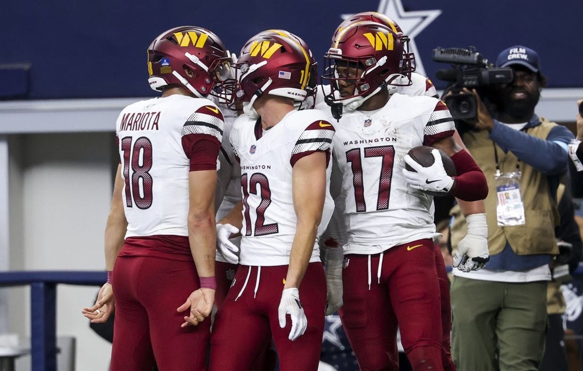 Jan 5, 2025; Arlington, Texas, USA;  Washington Commanders wide receiver Terry McLaurin (17) celebrates with Washington Commanders wide receiver Luke McCaffrey (12) and Washington Commanders quarterback Marcus Mariota (18) after scoring the game-winning touchdown  during the fourth quarter against the Dallas Cowboys at AT&T Stadium. Mandatory Credit: Kevin Jairaj-Imagn Images