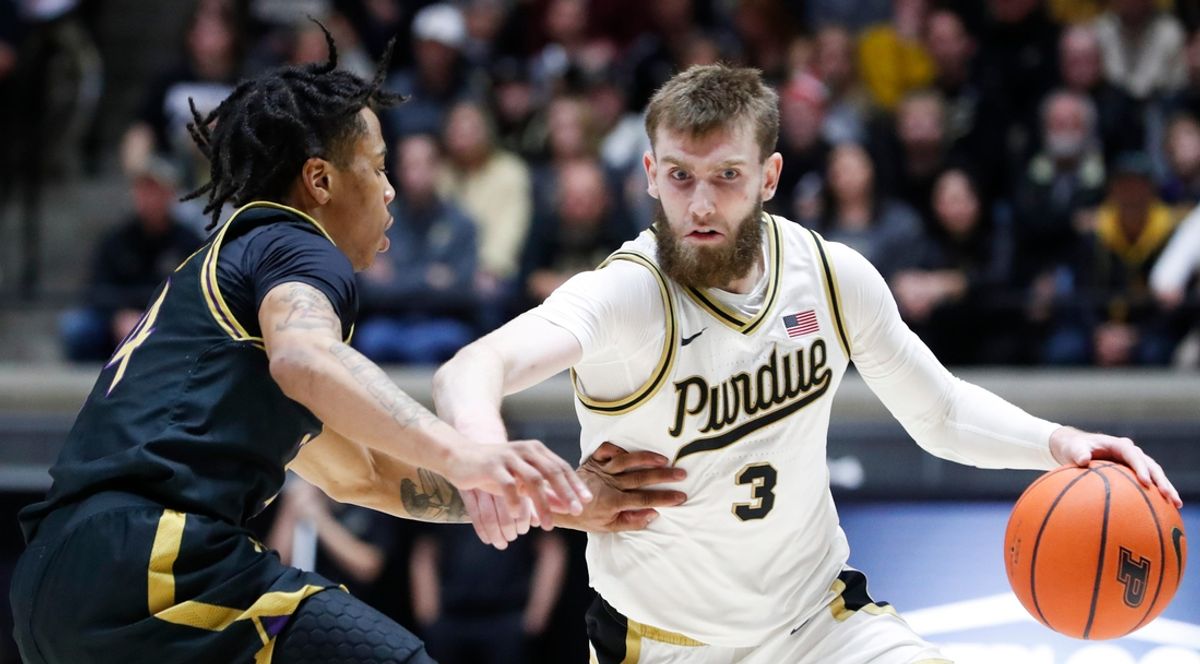 Northwestern Wildcats guard K.J. Windham (24) defends Purdue Boilermakers guard Braden Smith (3) Sunday, Jan. 5, 2025, during the NCAA men’s basketball game at Mackey Arena in West Lafayette, Ind. Purdue Boilermakers won 79-61.