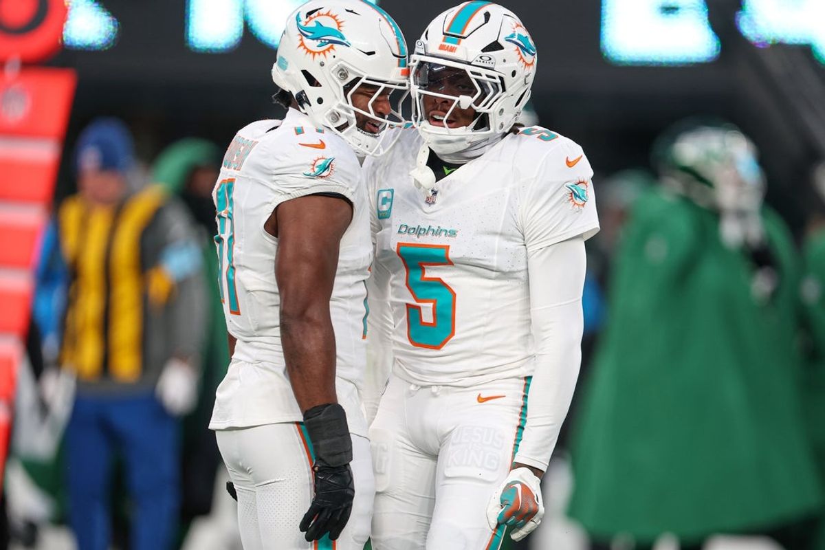 Jan 5, 2025; East Rutherford, New Jersey, USA; Miami Dolphins cornerback Jalen Ramsey (5) celebrates a defensive stop with linebacker Tyrel Dodson (11) during the first quarteragainst the New York Jets at MetLife Stadium. Mandatory Credit: Vincent Carchietta-Imagn Images
