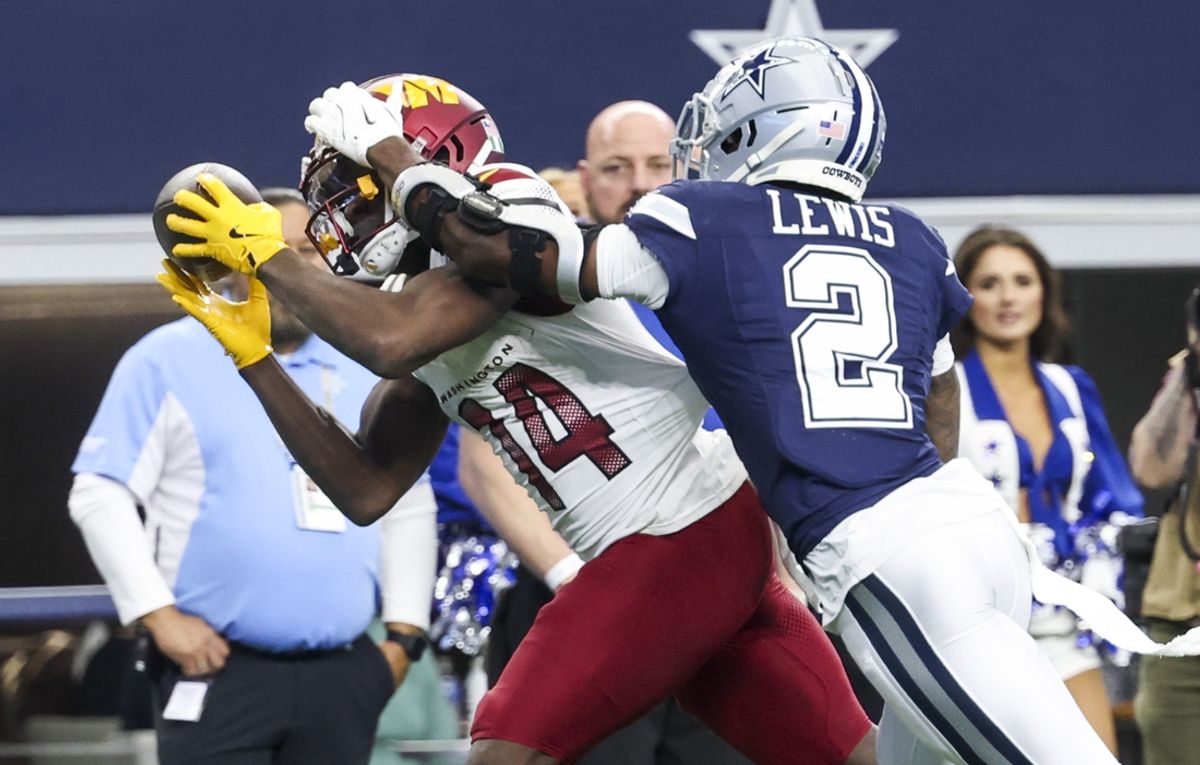 Jan 5, 2025; Arlington, Texas, USA;  Washington Commanders wide receiver Olamide Zaccheaus (14) makes a catch over Dallas Cowboys cornerback Jourdan Lewis (2) during the second half at AT&T Stadium. Mandatory Credit: Kevin Jairaj-Imagn Images