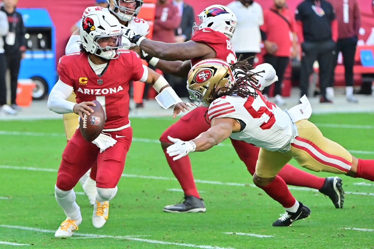 Jan 5, 2025; Glendale, Arizona, USA; Arizona Cardinals quarterback Kyler Murray (1) escapes a tackle by San Francisco 49ers linebacker Fred Warner (54) in the first half at State Farm Stadium. Mandatory Credit: Matt Kartozian-Imagn Images