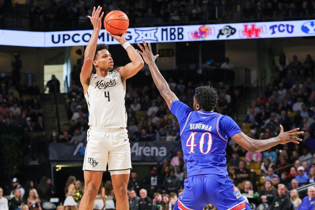 Jan 5, 2025; Orlando, Florida, USA; UCF Knights guard Keyshawn Hall (4) shoots over Kansas Jayhawks forward Flory Bidunga (40) during the first half at Addition Financial Arena. Mandatory Credit: Mike Watters-Imagn Images