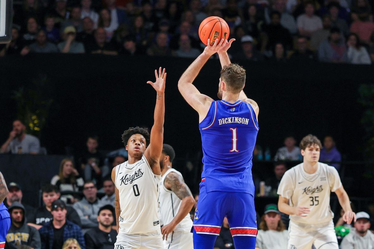 Jan 5, 2025; Orlando, Florida, USA; UCF Knights guard Jordan Ivy-Curry (0) defends Kansas Jayhawks center Hunter Dickinson (1) during the first half at Addition Financial Arena. Mandatory Credit: Mike Watters-Imagn Images