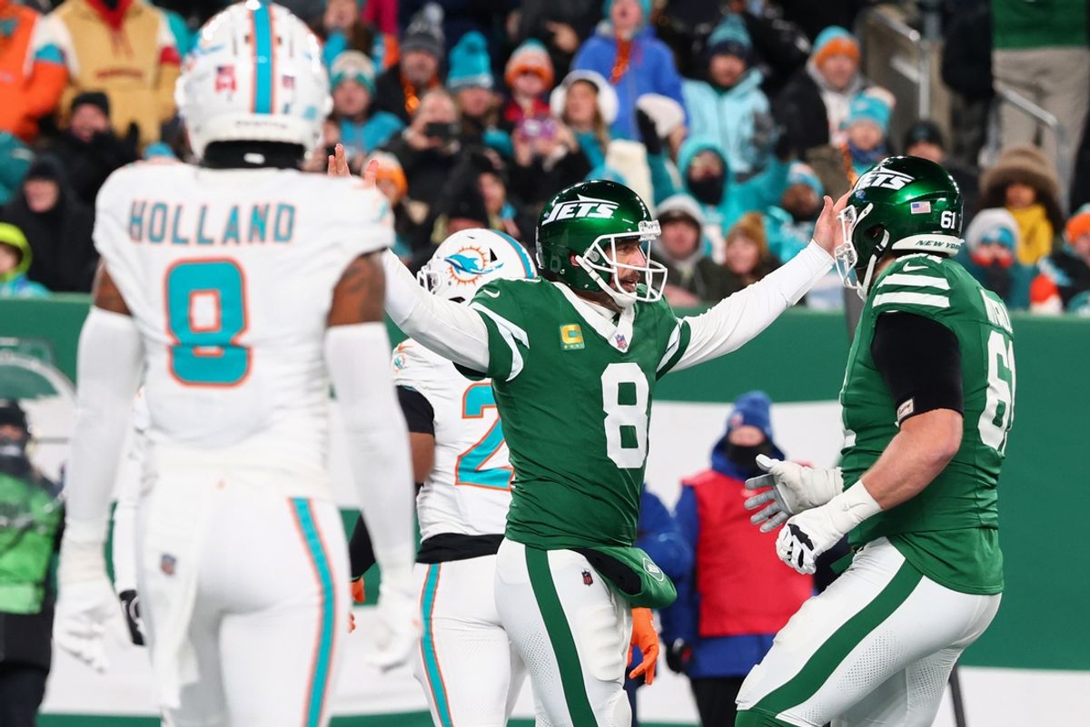 Jan 5, 2025; East Rutherford, New Jersey, USA; New York Jets quarterback Aaron Rodgers (8) celebrates after throwing his 500th touchdown pass during the second quarter of their game against the Miami Dolphins at MetLife Stadium. Mandatory Credit: Ed Mulholland-Imagn Images