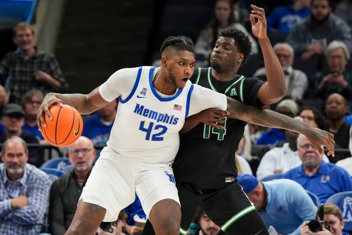 Memphis' Dain Dainja (42) drives to the basket as North Texas' Moulaye Sissoko (14) guards him during the game between the University of North Texas and the University of Memphis at FedExForum in Memphis, Tenn., on Sunday, January 5, 2025.