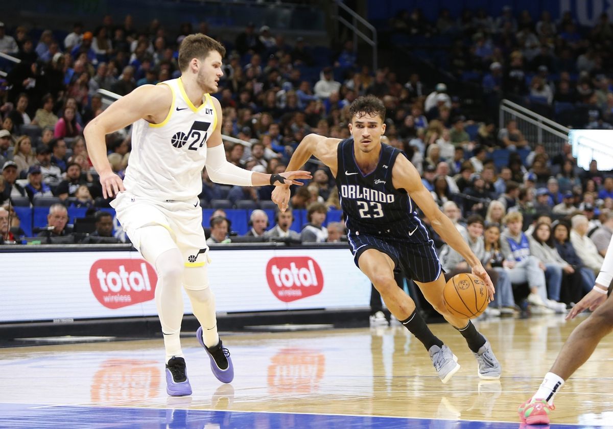 Jan 5, 2025; Orlando, Florida, USA;  Orlando Magic forward Tristan da Silva (23) drives to the basket as Utah Jazz center Walker Kessler (24) defends at Kia Center. Mandatory Credit: Russell Lansford-Imagn Images
