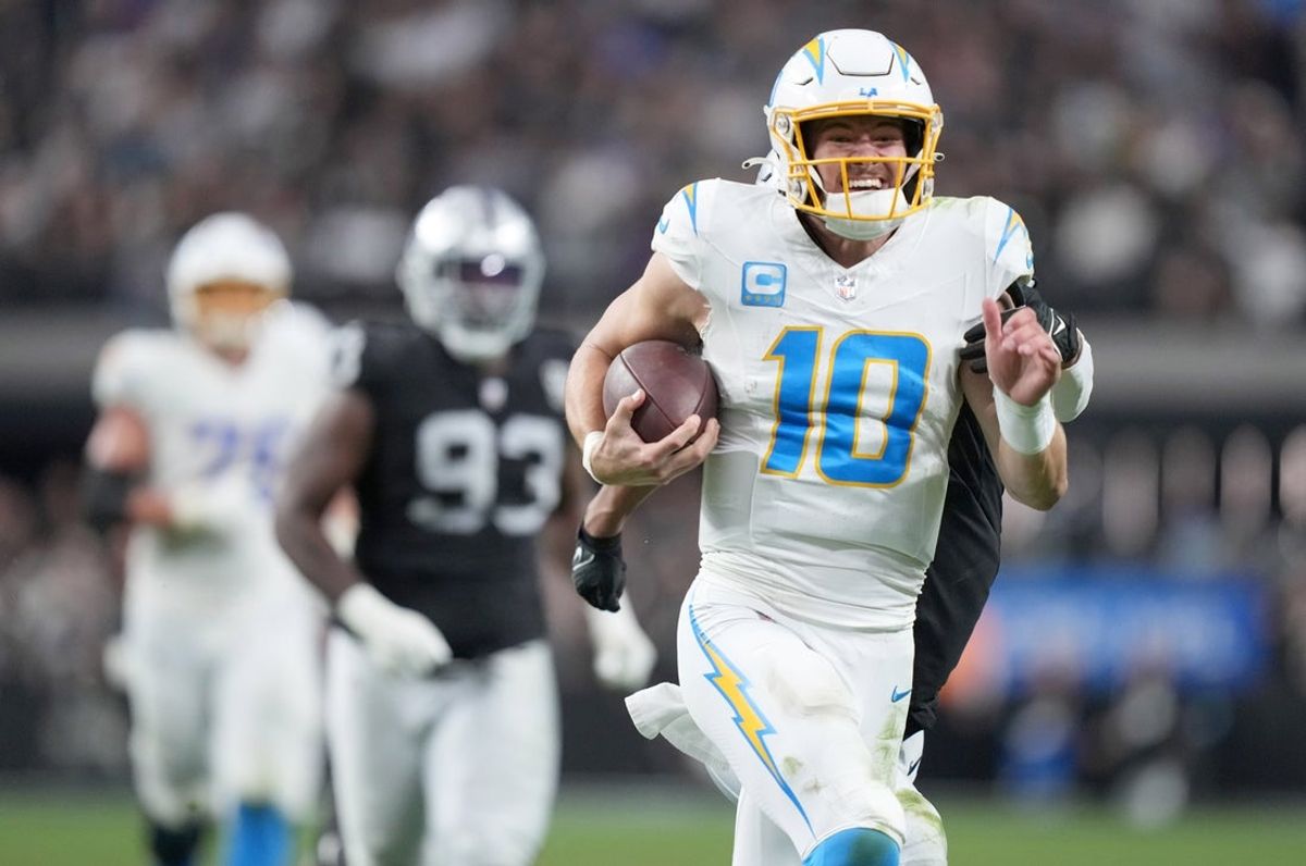 Jan 5, 2025; Paradise, Nevada, USA; Los Angeles Chargers quarterback Justin Herbert (10) carries the ball on a 41-yard run in the second half against the Las Vegas Raiders Allegiant Stadium. Mandatory Credit: Kirby Lee-Imagn Images