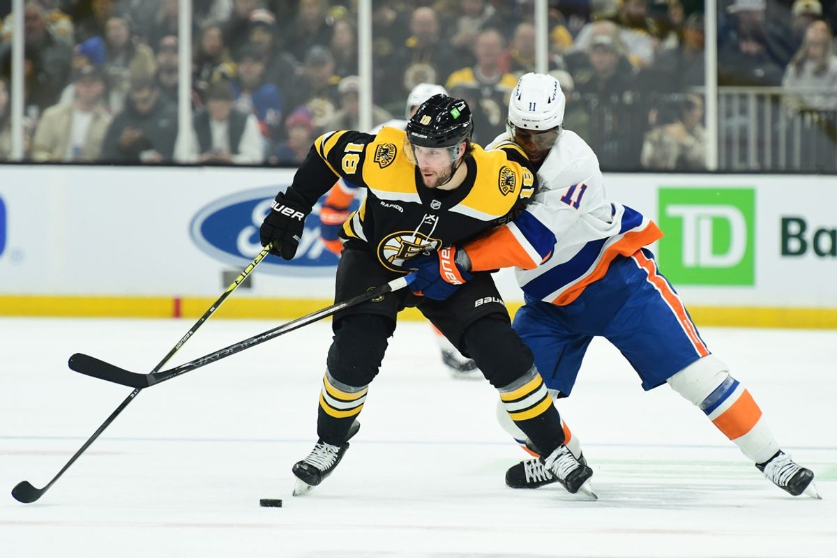 Jan 5, 2025; Boston, Massachusetts, USA; Boston Bruins center Pavel Zacha (18) and New York Islanders left wing Anthony Duclair (11) battle for the puck during the second period at TD Garden. Mandatory Credit: Bob DeChiara-Imagn Images