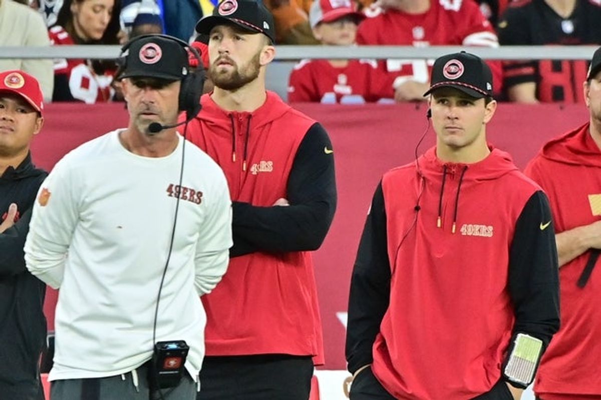 Jan 5, 2025; Glendale, Arizona, USA;  San Francisco 49ers quarterback Brock Purdy (right) and head coach Kyle Shanahan (left) look on the in second half against the Arizona Cardinals at State Farm Stadium. Mandatory Credit: Matt Kartozian-Imagn Images