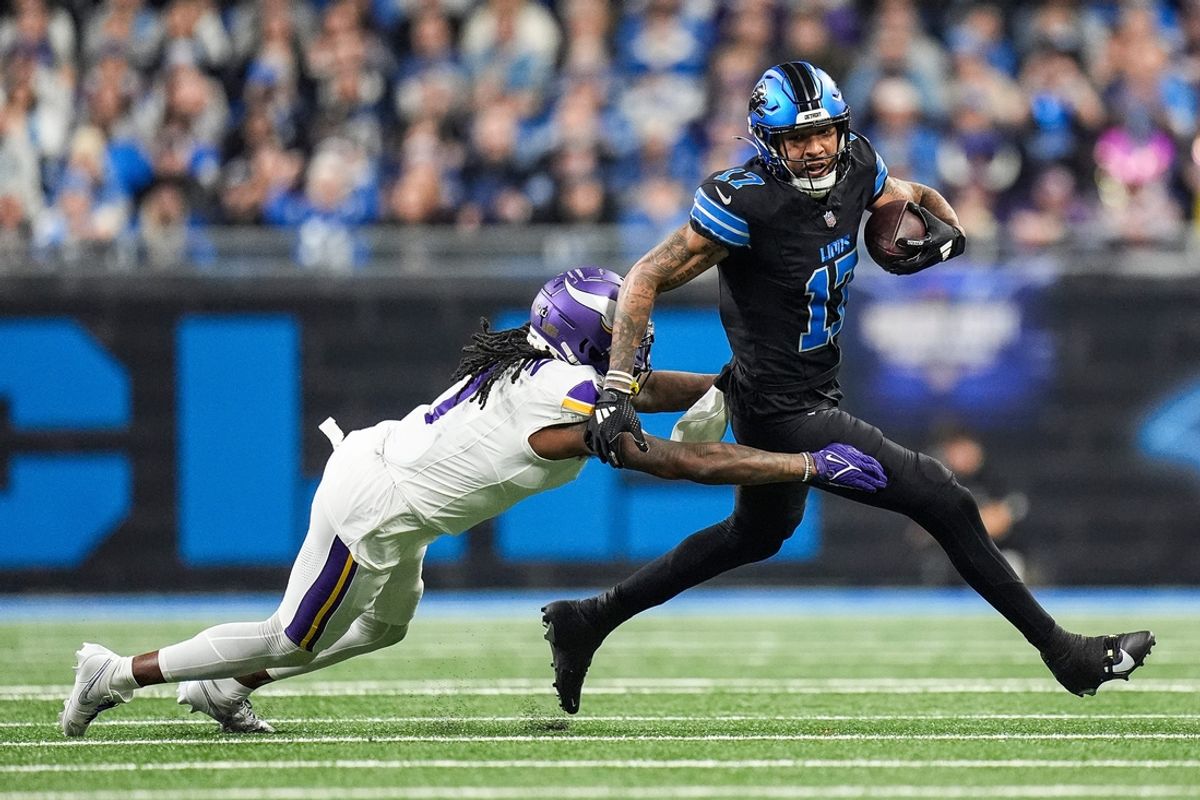 Detroit Lions wide receiver Tim Patrick (17) makes a catch and runs against Minnesota Vikings cornerback Shaquill Griffin (1) during the first half at Ford Field in Detroit on Sunday, Jan. 5, 2025.