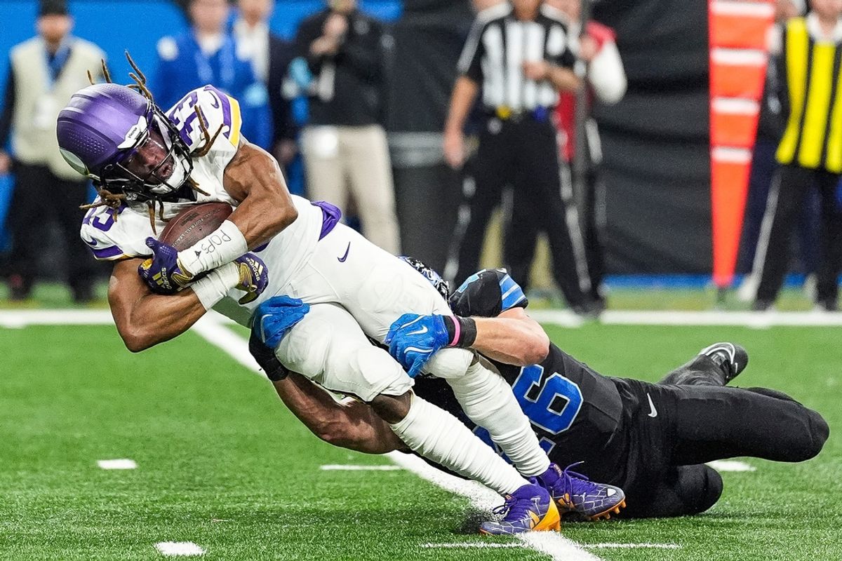 Minnesota Vikings running back Aaron Jones (33) makes a catch against Detroit Lions linebacker Jack Campbell (46) during the first half at Ford Field in Detroit on Sunday, Jan. 5, 2025.