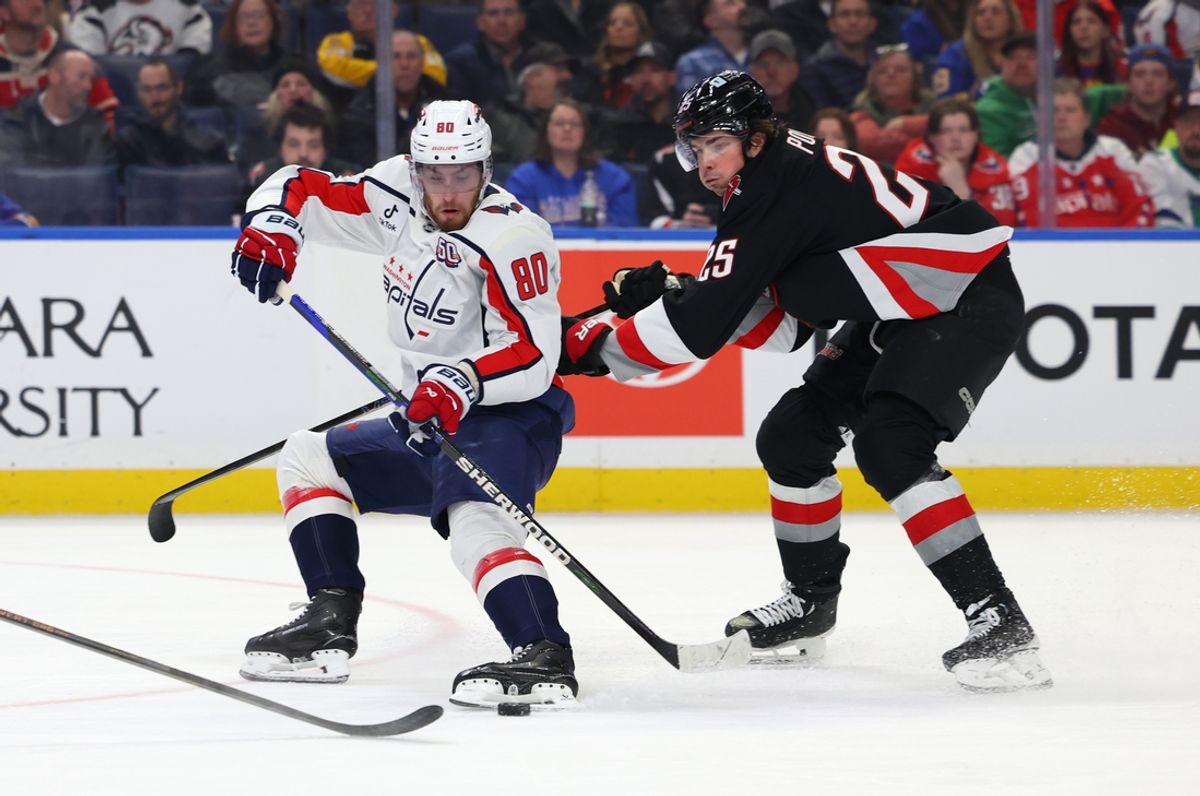 Jan 6, 2025; Buffalo, New York, USA;  Washington Capitals left wing Pierre-Luc Dubois (80) looks to control the puck as Buffalo Sabres defenseman Owen Power (25) defends during the first period at KeyBank Center. Mandatory Credit: Timothy T. Ludwig-Imagn Images