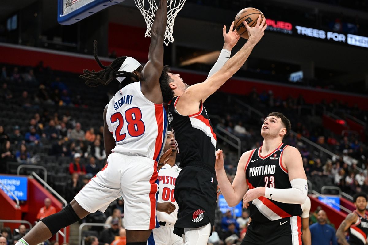 Jan 6, 2025; Detroit, Michigan, USA;  Portland Trail Blazers forward Deni Avdija (8) shoots a reverse layup over Detroit Pistons center Isaiah Stewart (28) in the first quarter at Little Caesars Arena. Mandatory Credit: Lon Horwedel-Imagn Images