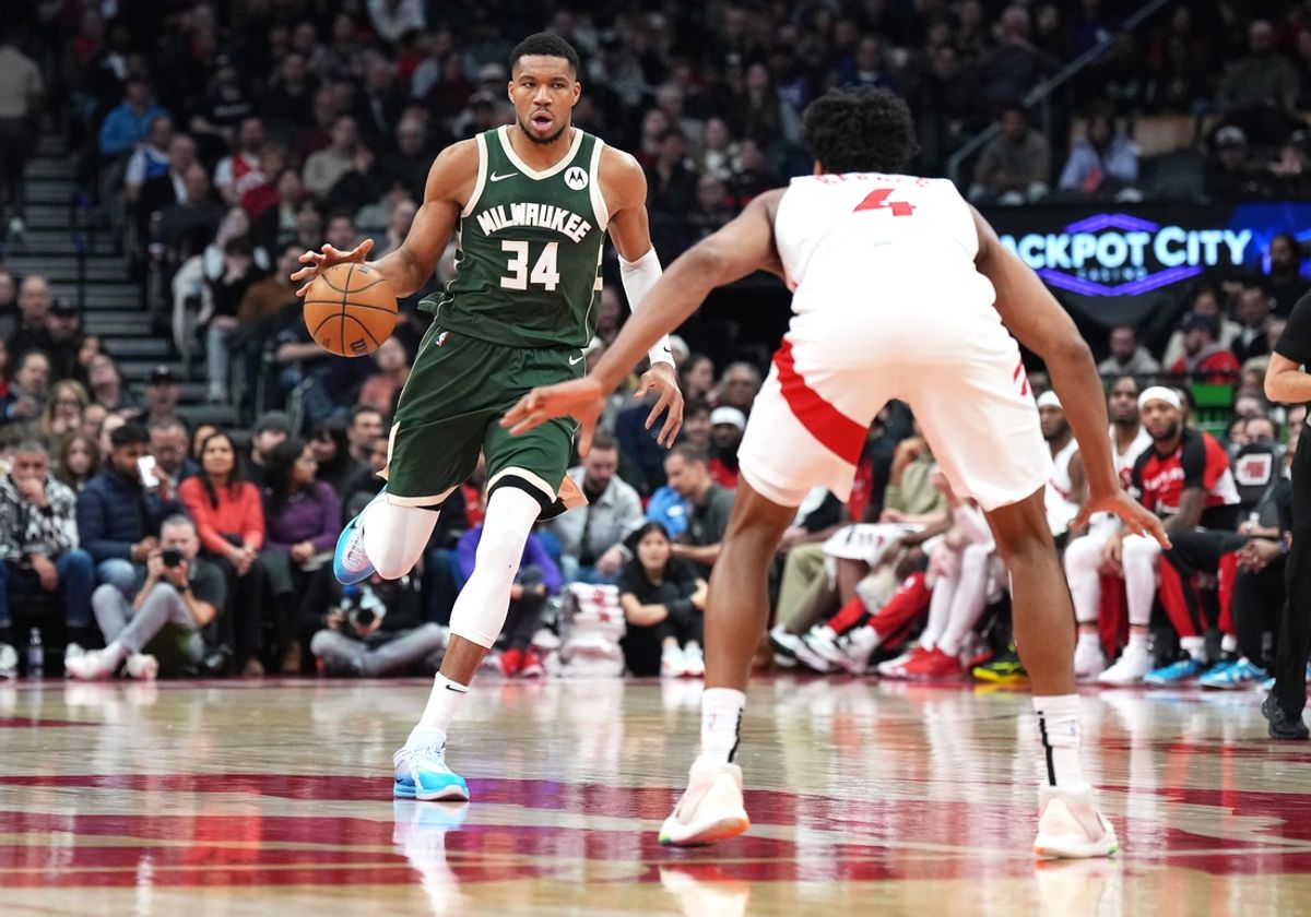 Jan 6, 2025; Toronto, Ontario, CAN;Milwaukee Bucks forward Giannis Antetokounmpo (34) dribbles the ball as Toronto Raptors forward Scottie Barnes (4) defends during the second quarter at Scotiabank Arena. Mandatory Credit: Nick Turchiaro-Imagn Images