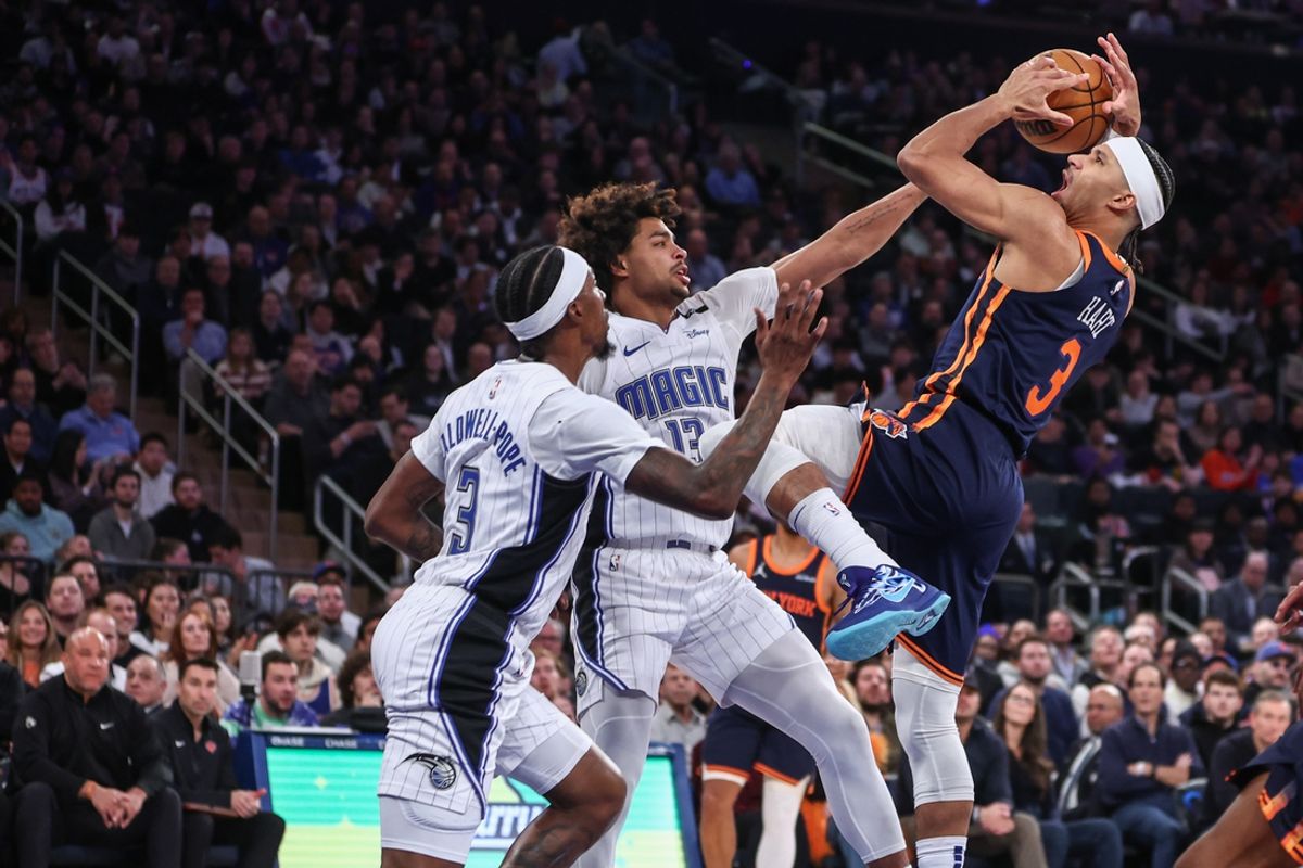 Jan 6, 2025; New York, New York, USA;  New York Knicks guard Josh Hart (3) looks to shoot over Orlando Magic guards Jett Howard (13) and Kentavious Caldwell-Pope (3) in the second quarter at Madison Square Garden. Mandatory Credit: Wendell Cruz-Imagn Images