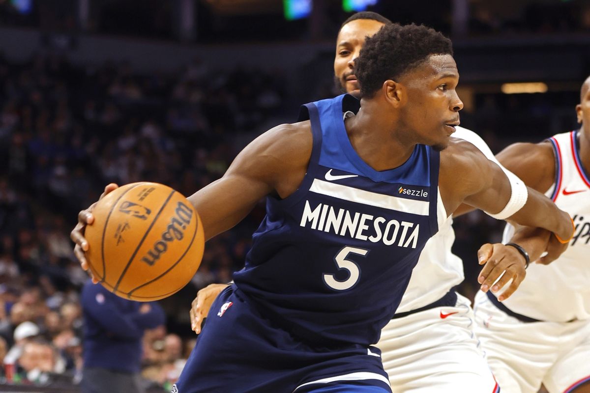 Jan 6, 2025; Minneapolis, Minnesota, USA; Minnesota Timberwolves guard Anthony Edwards (5) dribbles past Los Angeles Clippers guard Norman Powell (24) in the first quarter at Target Center. Mandatory Credit: Bruce Kluckhohn-Imagn Images