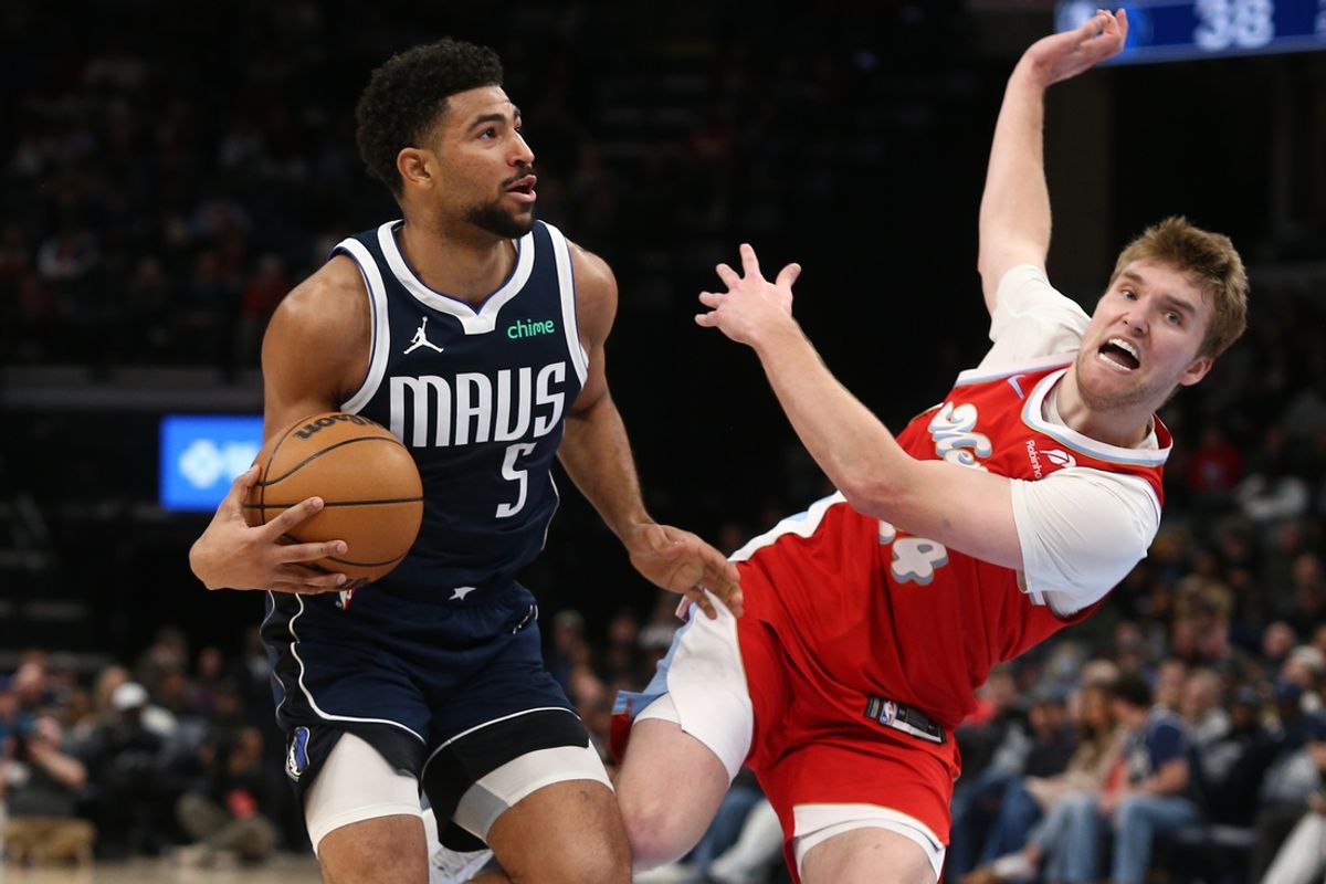 Jan 6, 2025; Memphis, Tennessee, USA; Dallas Mavericks guard Quentin Grimes (5) drives to the basket as Memphis Grizzlies guard Cam Spencer (24) defends during the second quarter at FedExForum. Mandatory Credit: Petre Thomas-Imagn Images