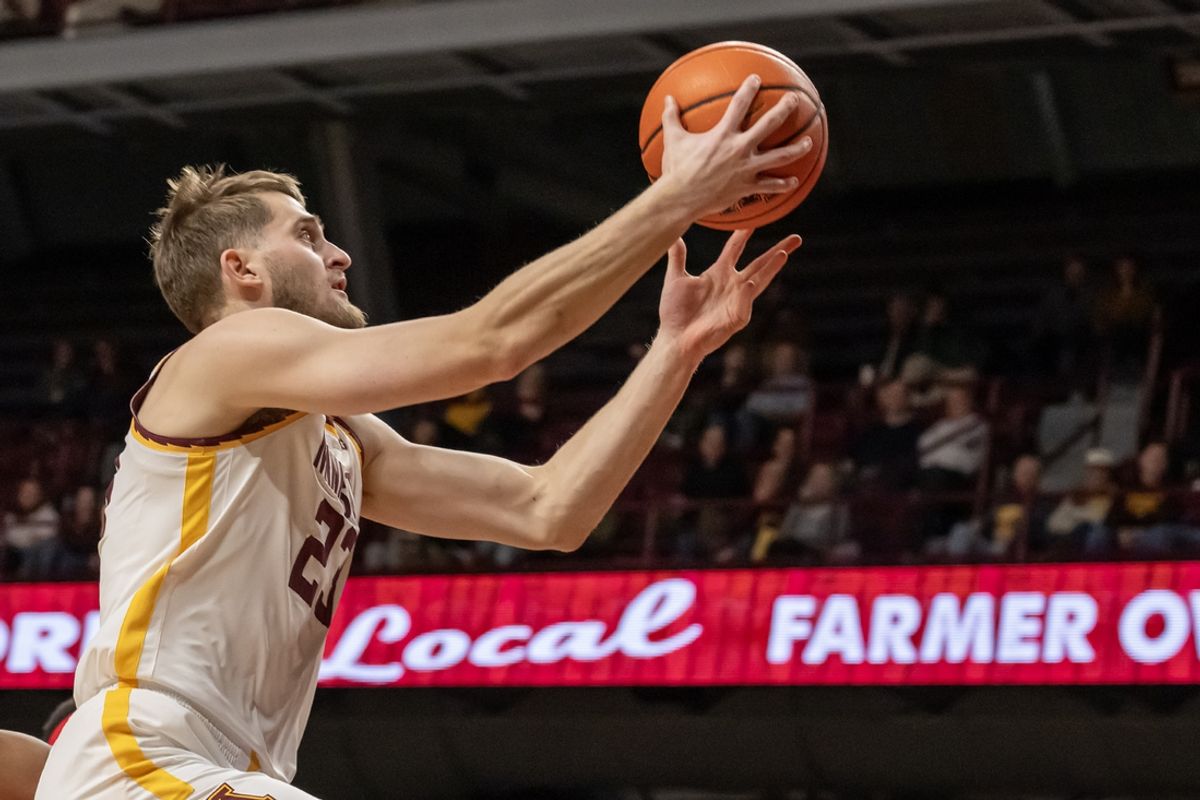 Jan 6, 2025; Minneapolis, Minnesota, USA;  Minnesota Golden Gophers forward Parker Fox (23) scores on a layup against the Ohio State Buckeyes during the first half at Williams Arena. Mandatory Credit: Nick Wosika-Imagn Images