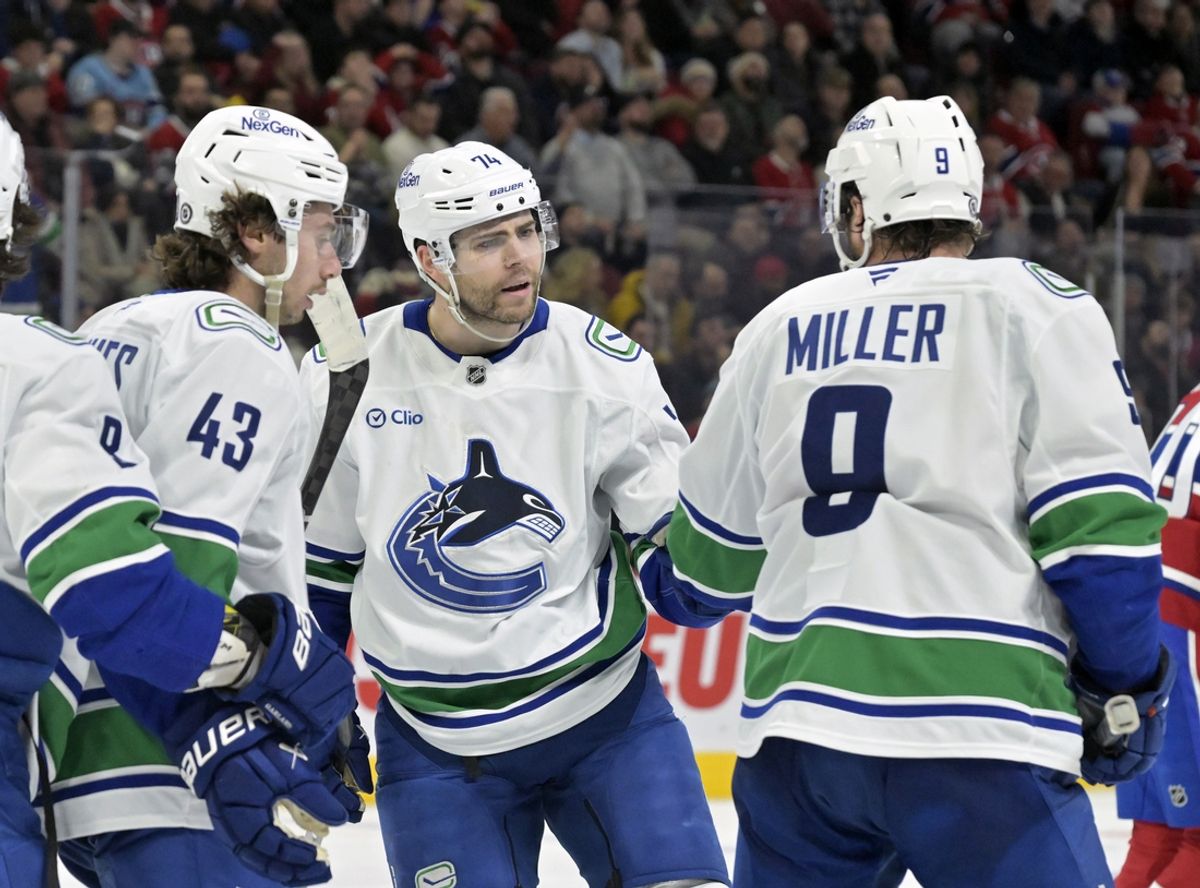 Jan 6, 2025; Montreal, Quebec, CAN; Vancouver Canucks forward Jake Debrusk (74) celebrates with teammates including forward J.T. Miller (9) after scoring a goal against the Montreal Canadiens during the third period at the Bell Centre. Mandatory Credit: Eric Bolte-Imagn Images