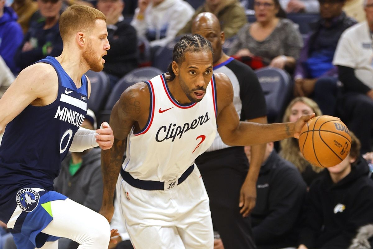 Jan 6, 2025; Minneapolis, Minnesota, USA; Los Angeles Clippers forward Kawhi Leonard (2) dribbles past Minnesota Timberwolves guard Donte DiVincenzo (0) in the third quarter at Target Center. Mandatory Credit: Bruce Kluckhohn-Imagn Images